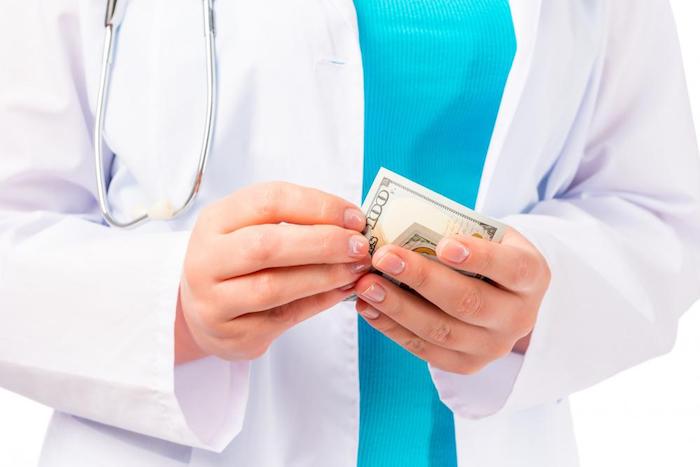 image of a doctor holding money