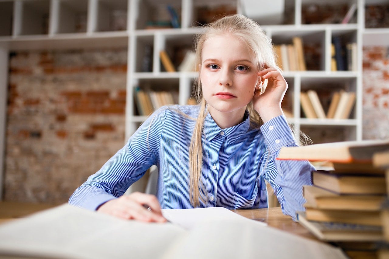 young woman teen reading about fentanyl